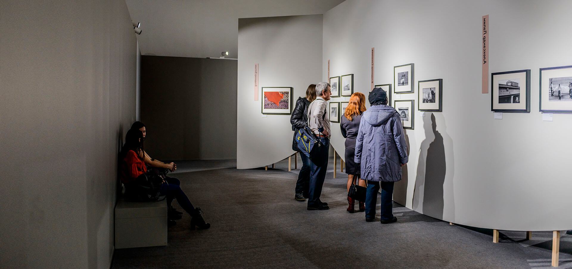 Visitors explore a photography exhibit in a gallery