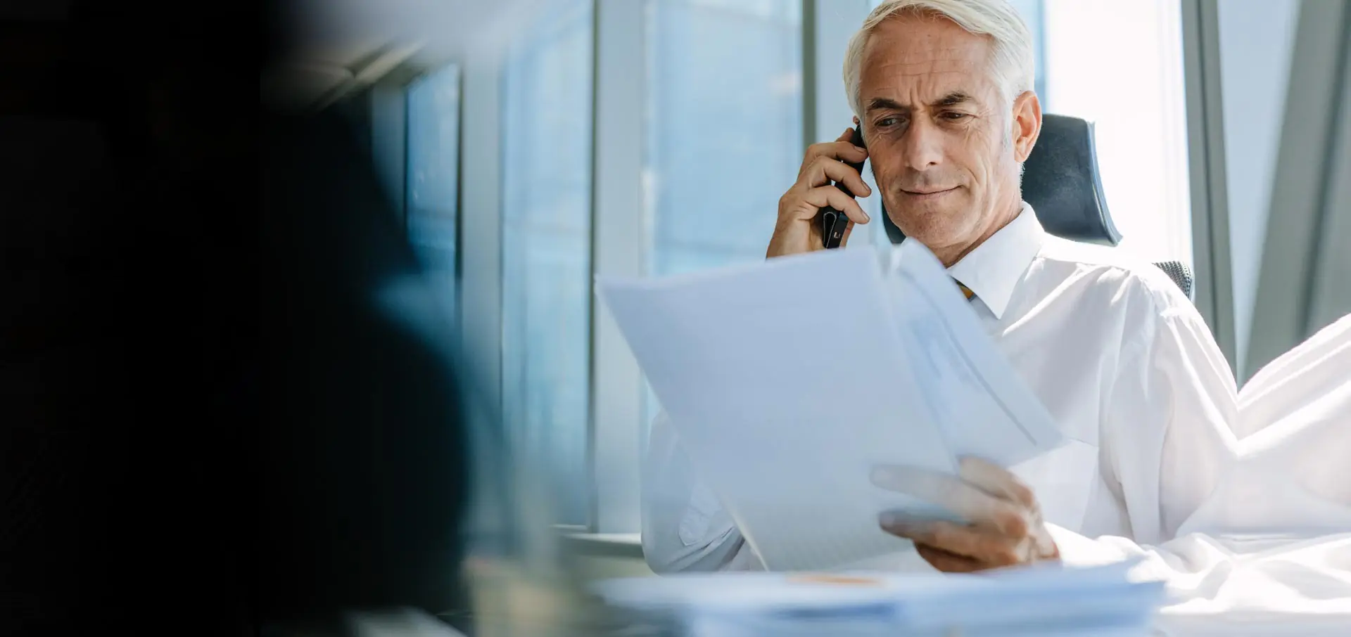 Senior manager on a business call on his cellphone