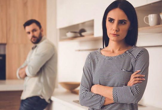 Married couple having a difficult conversation in the kitchen